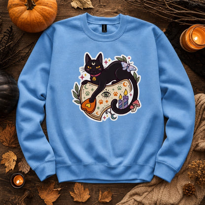 Black cat witch familiar ouija planchette Halloween crewneck sweatshirt with candles moth and moon, styled flat lay, no model