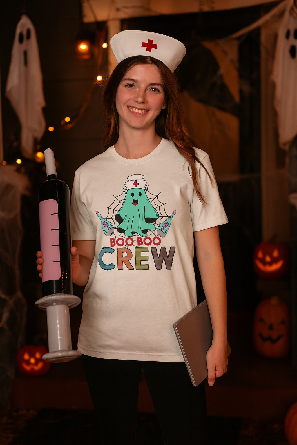 Boo Boo Crew Halloween nurse ghost graphic tee printed on BELLA+CANVAS 3001 unisex short sleeve shirt worn by a model
