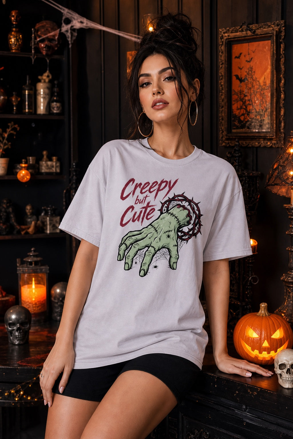 Creepy but Cute zombie hand thorn crown spiderweb Halloween graphic tee on white shirt worn by a model