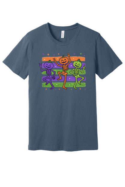 Dancing pumpkin head skeletons Halloween unisex tee in purple orange and green on striped background in Slate