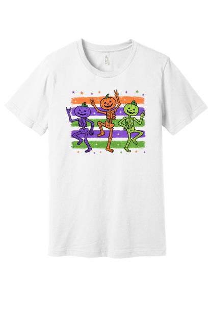 Dancing pumpkin head skeletons Halloween unisex tee in purple orange and green on striped background in White