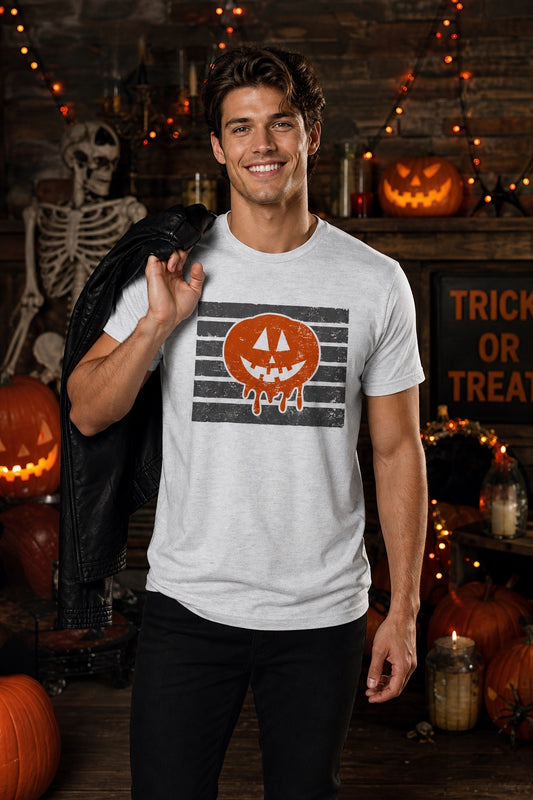 Dripping jack-o-lantern Halloween graphic tee with melting pumpkin face on black stripe print worn by a model