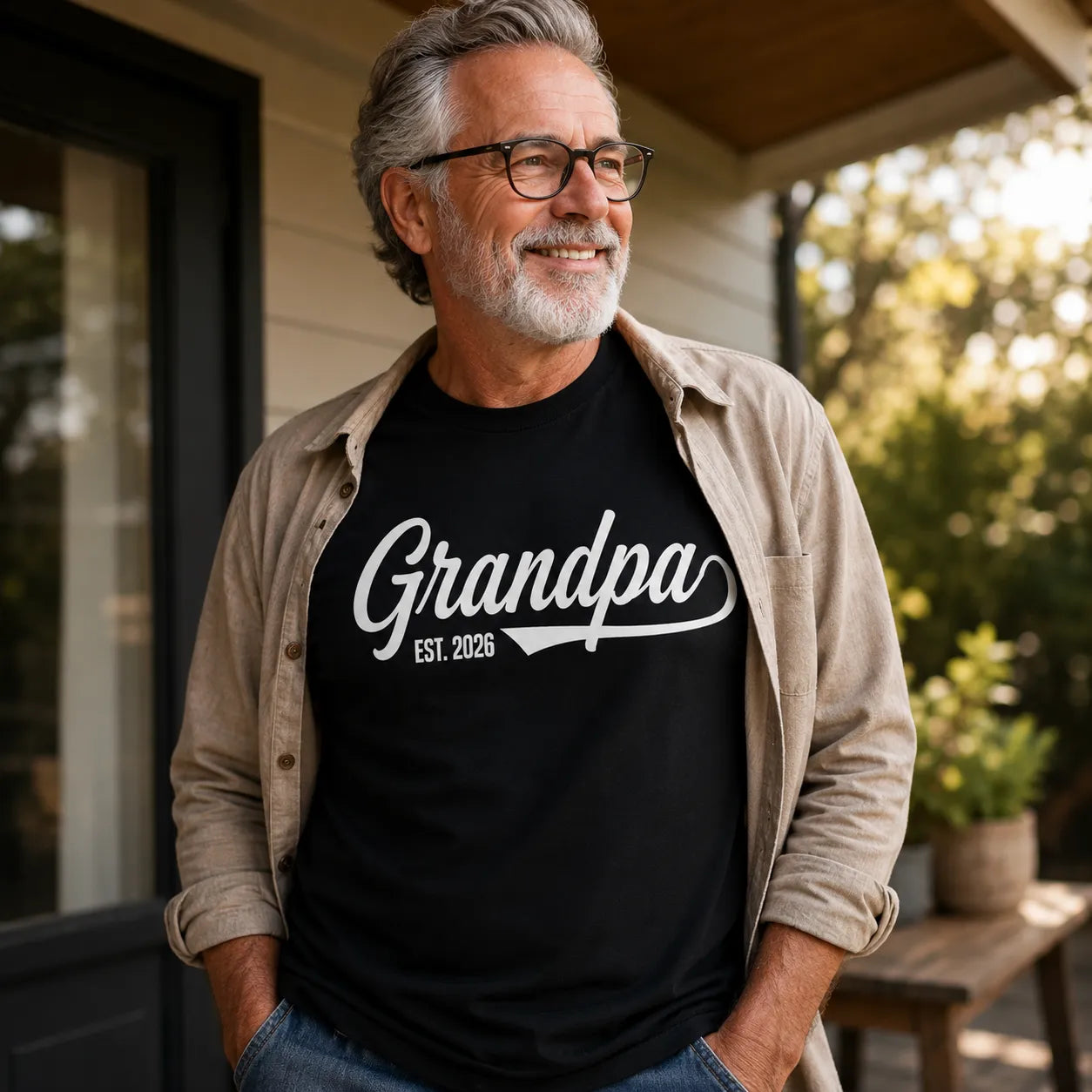 Personalized grandpa est. year t-shirt worn by a modern grandfather in a warm outdoor lifestyle setting