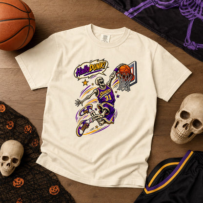 HalloDunk skeleton basketball dunk comic pop art print on Comfort Colors heavyweight tee, purple gold, styled flat lay, no model