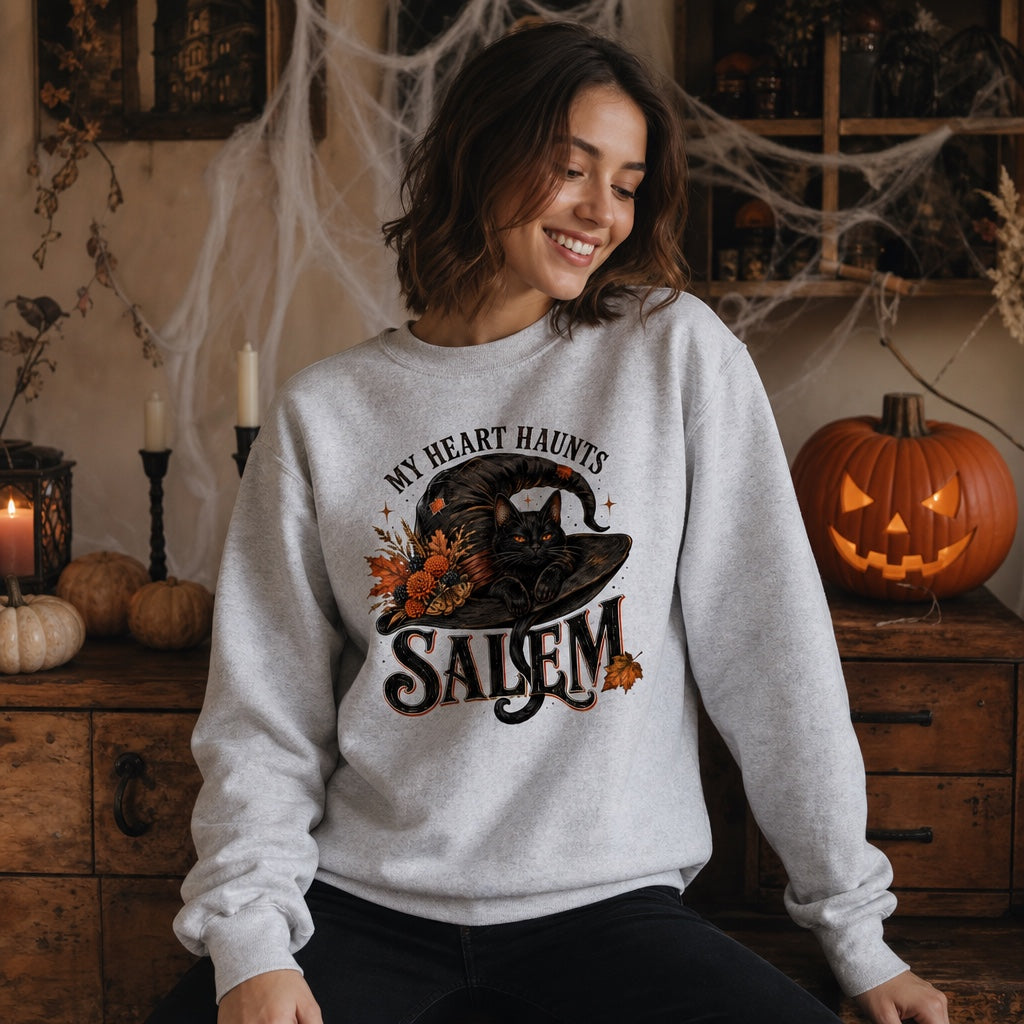 My Heart Haunts Salem black cat witch hat Halloween crewneck sweatshirt with autumn floral DTF print, worn by a model