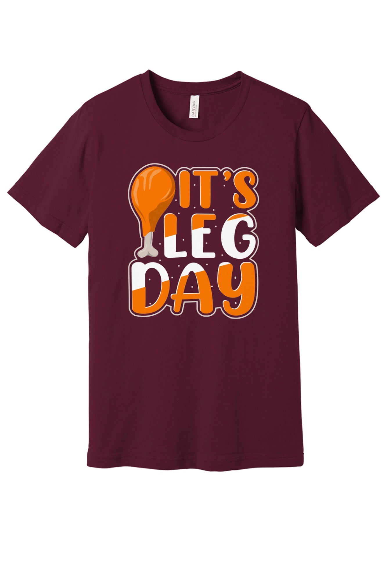 IT'S LEG DAY funny Thanksgiving drumstick graphic printed on a BELLA+CANVAS unisex tee in Maroon