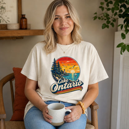 Lake Ontario vintage sunset lighthouse graphic tee with sailboats and seagulls, bold retro script design, worn by a model