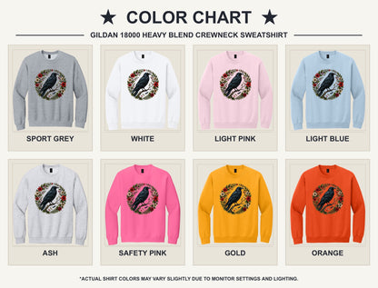 Raven perched on branch inside red floral botanical wreath, printed on a Halloween crewneck sweatshirt - available shirt colors chart