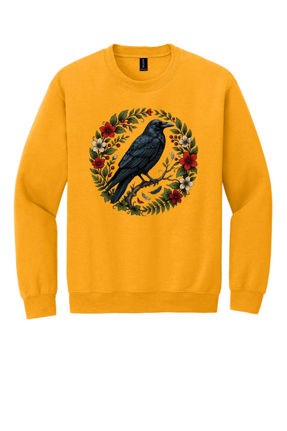 Raven perched on branch inside red floral botanical wreath, printed on a Halloween crewneck sweatshirt in Gold