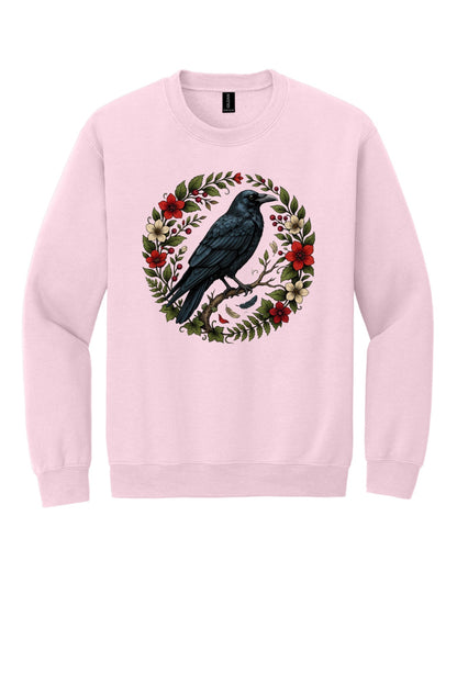 Raven perched on branch inside red floral botanical wreath, printed on a Halloween crewneck sweatshirt in Light Pink