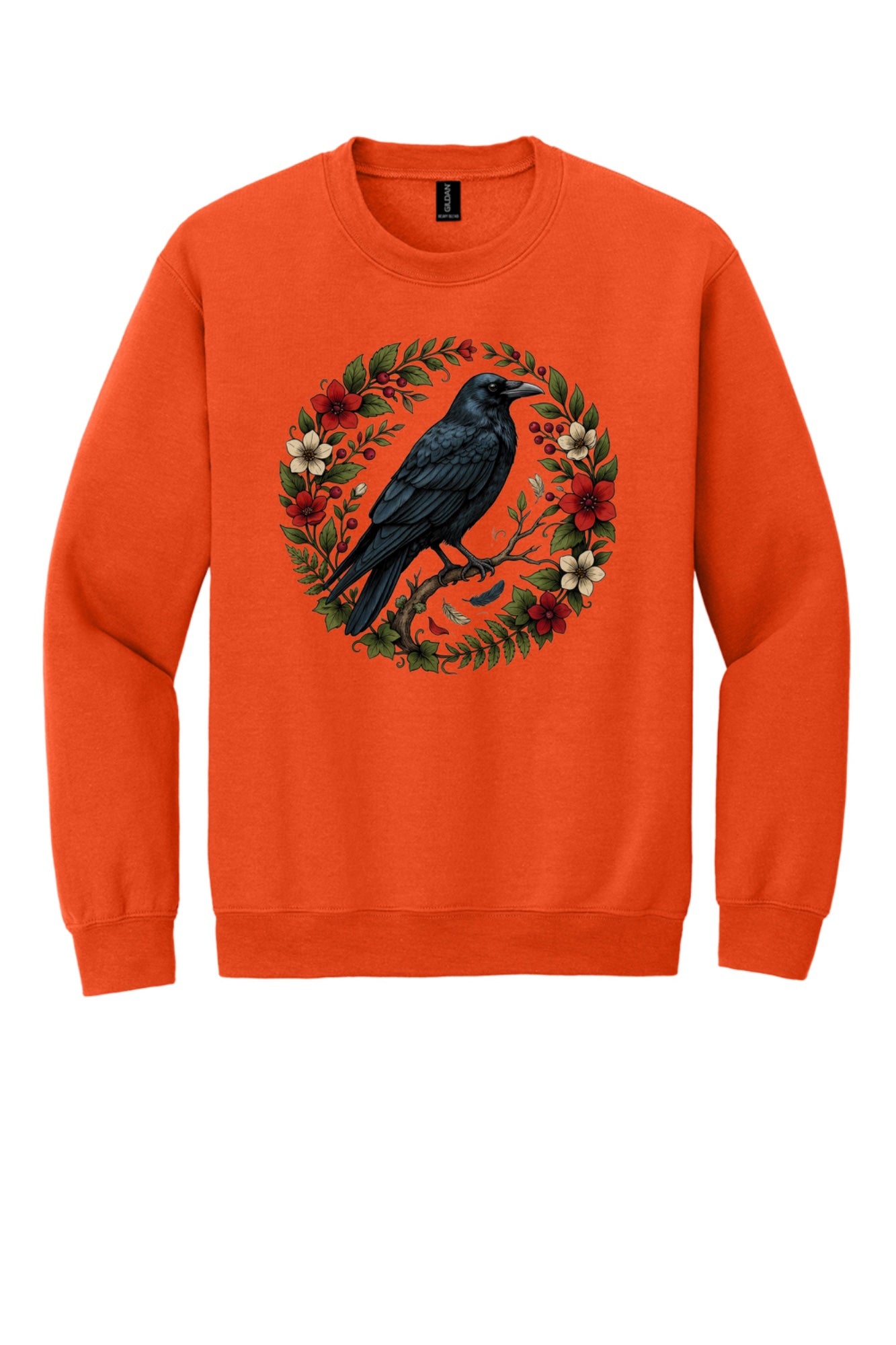 Raven perched on branch inside red floral botanical wreath, printed on a Halloween crewneck sweatshirt in Orange