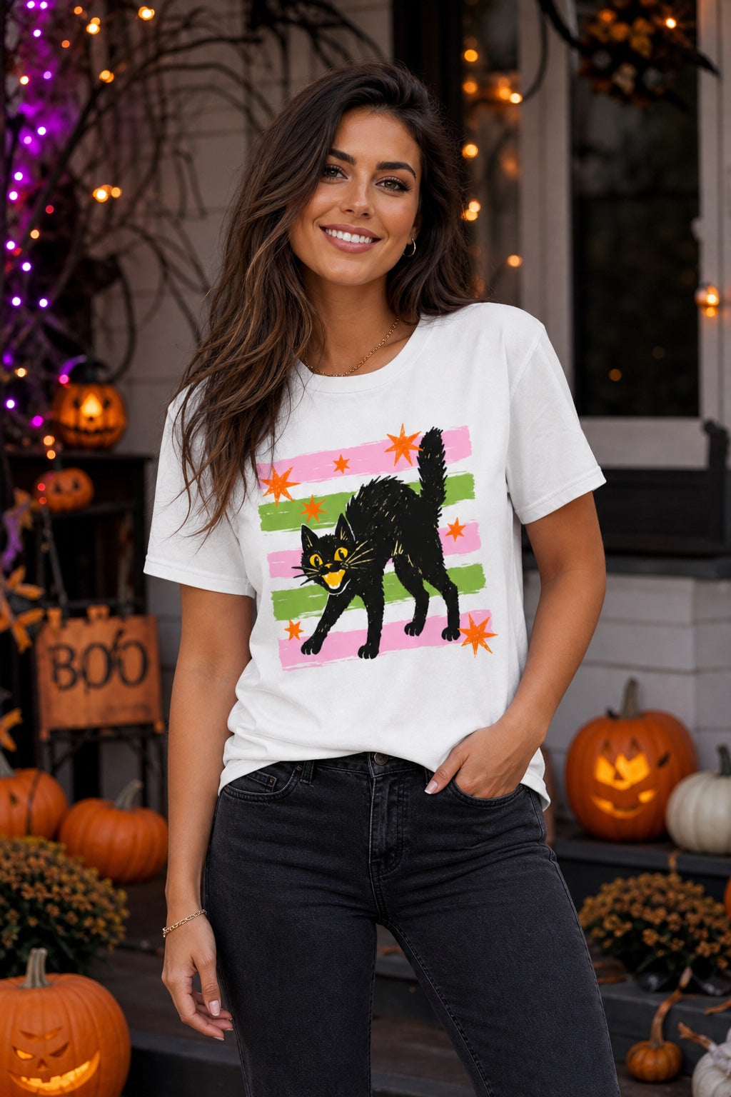 Scaredy cat Halloween tee with hissing black cat, orange stars and pink green stripes, BELLA+CANVAS unisex shirt worn by a model