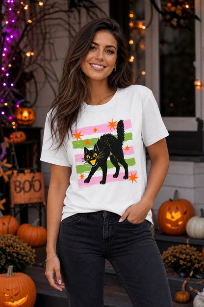 Scaredy cat Halloween tee with hissing black cat, orange stars and pink green stripes, BELLA+CANVAS unisex shirt worn by a model