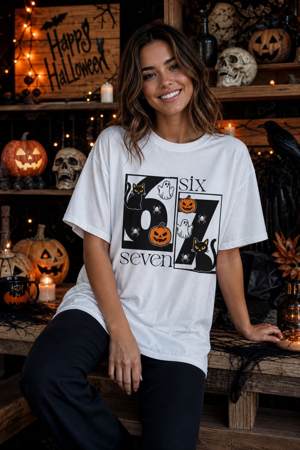 Six Seven Halloween tee with black cats ghosts pumpkins and spiders printed on a unisex short sleeve shirt worn by a model