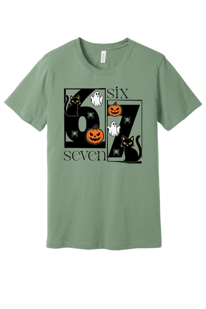 Six Seven Halloween tee with black cats ghosts pumpkins and spiders printed on a unisex short sleeve shirt in Sage