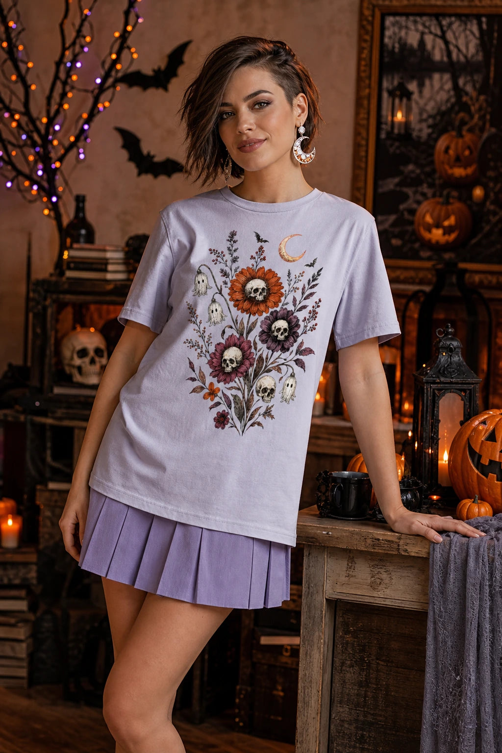 Halloween tee with skull center flowers, ghost bell blossoms, bats and crescent moon gothic botanical print worn by a model