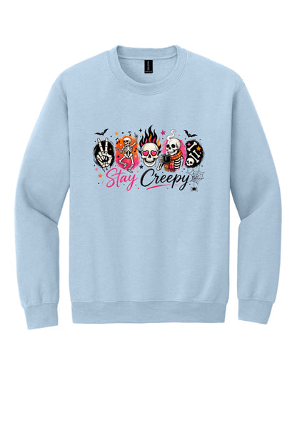 Stay Creepy skeleton Halloween crewneck sweatshirt with flaming skull and heart-eyes DTF print, Gildan 18000 in Light Blue