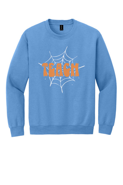 Teach groovy retro bubble letter Halloween crewneck sweatshirt, warm orange DTF print on dark fabric in Carolina Blue