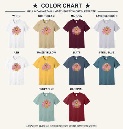 Colorful cartoon girl turkey with bow and tie-dye swirl feathers printed on a unisex Thanksgiving tee - available shirt colors chart
