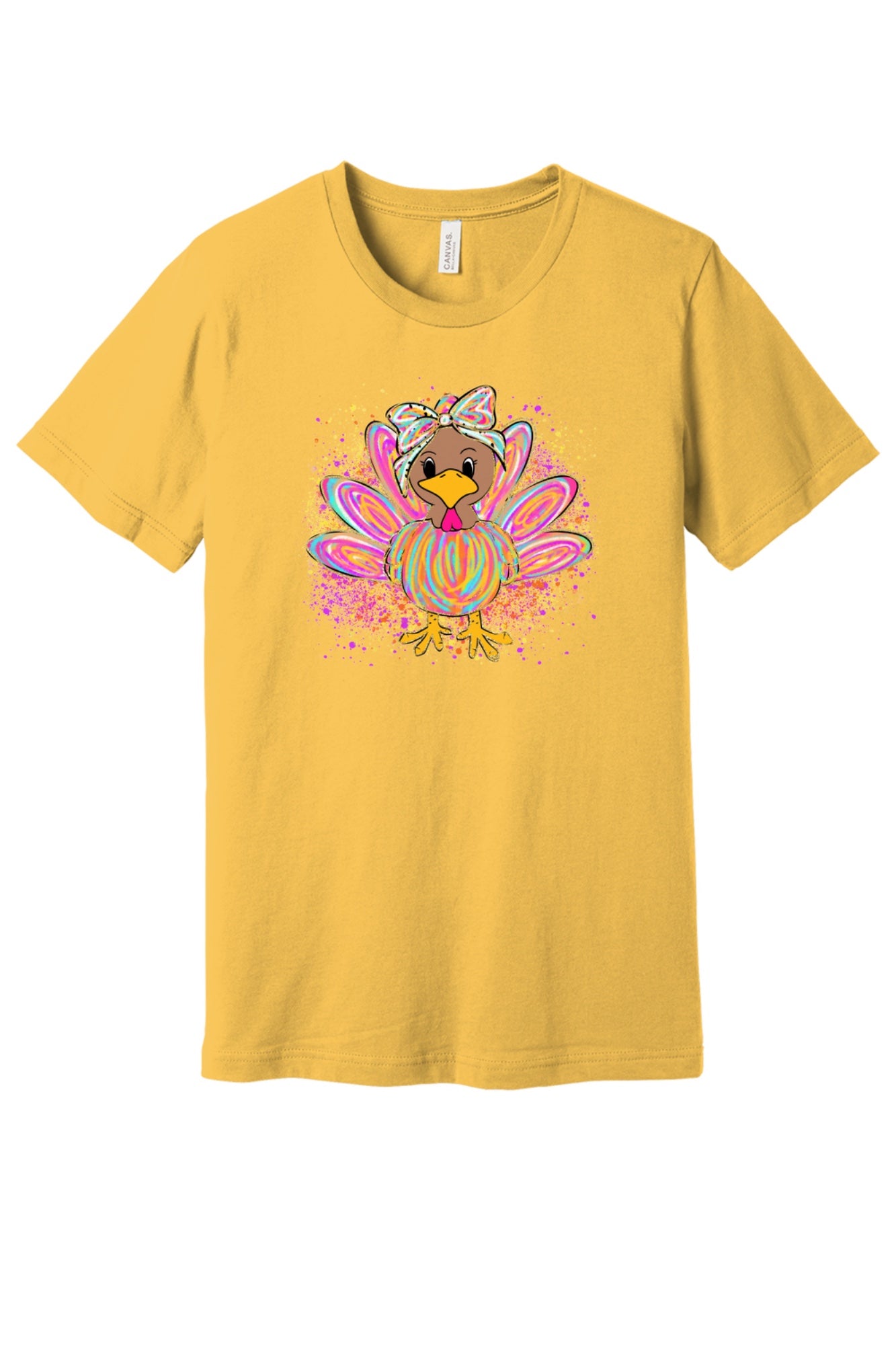 Colorful cartoon girl turkey with bow and tie-dye swirl feathers printed on a unisex Thanksgiving tee in Maize Yellow