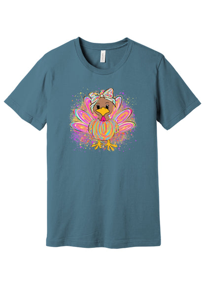 Colorful cartoon girl turkey with bow and tie-dye swirl feathers printed on a unisex Thanksgiving tee in Steel Blue