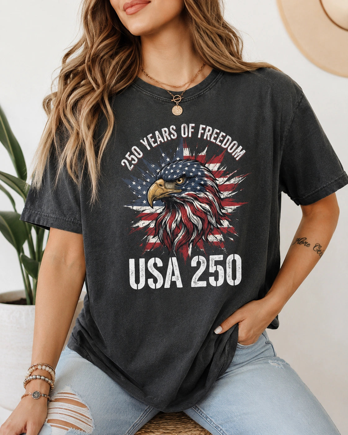 Woman wearing USA 250 patriotic eagle graphic t-shirt on vintage washed Comfort Colors heavyweight tee