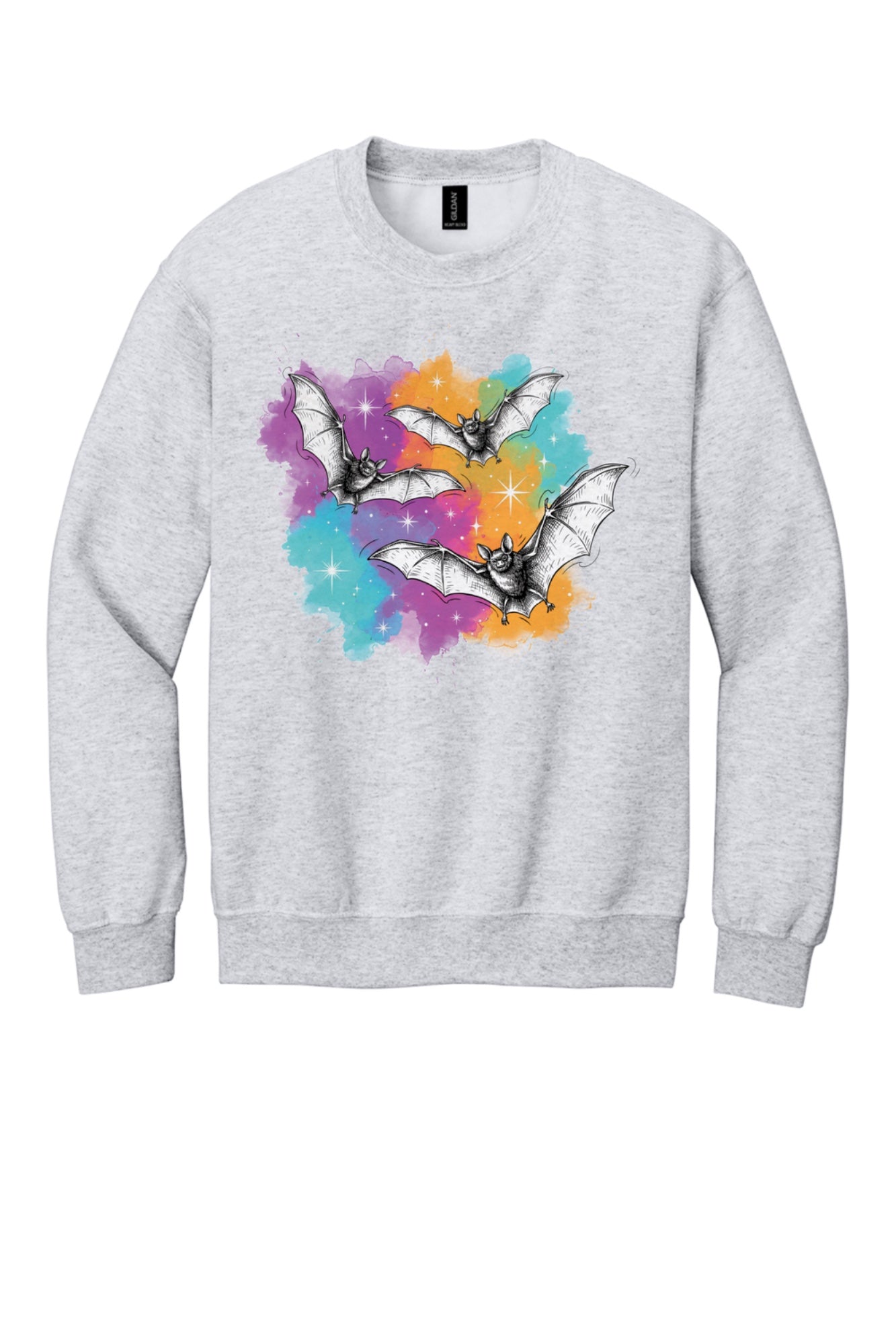Gildan 18000 crewneck sweatshirt with three sketch-style flying bats over a watercolor purple teal orange sparkle Halloween print in Ash