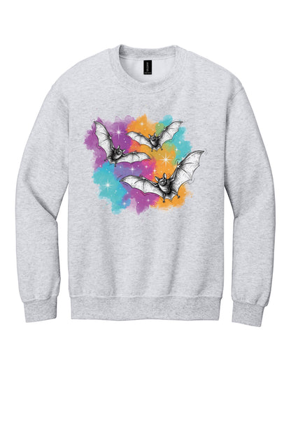 Gildan 18000 crewneck sweatshirt with three sketch-style flying bats over a watercolor purple teal orange sparkle Halloween print in Ash