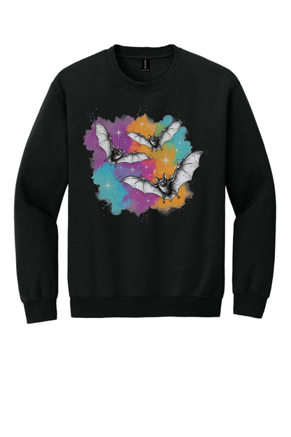 Gildan 18000 crewneck sweatshirt with three sketch-style flying bats over a watercolor purple teal orange sparkle Halloween print in Black