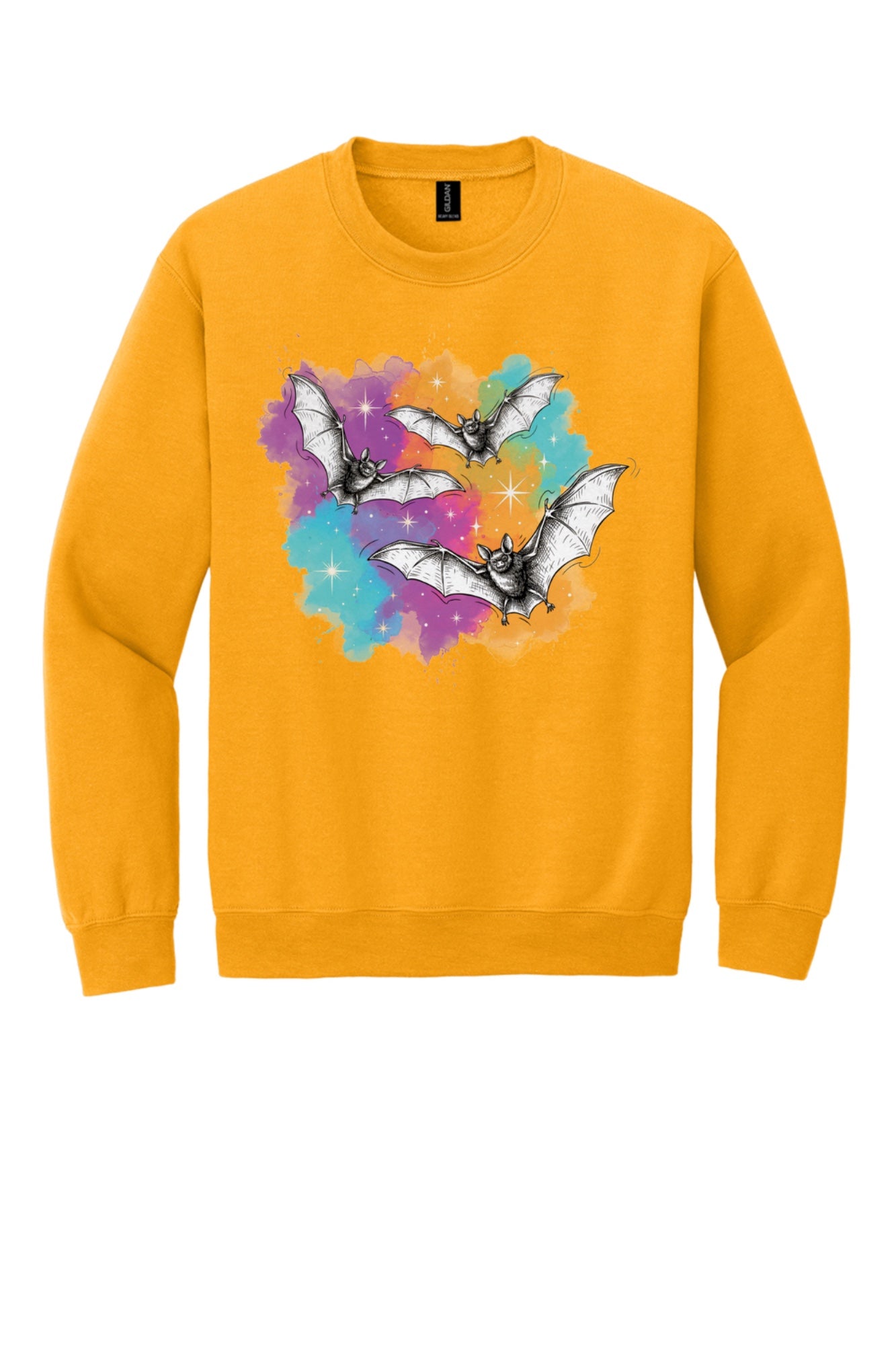 Gildan 18000 crewneck sweatshirt with three sketch-style flying bats over a watercolor purple teal orange sparkle Halloween print in Gold