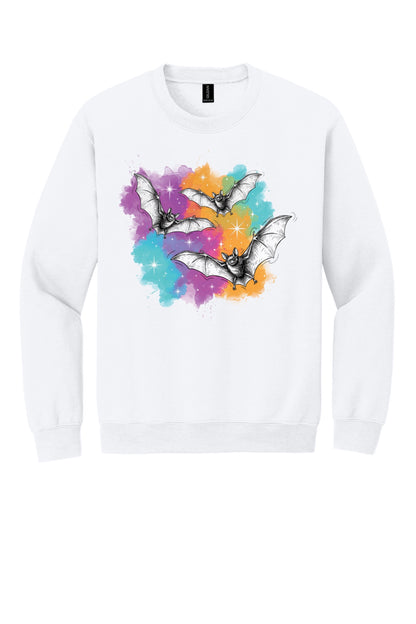 Gildan 18000 crewneck sweatshirt with three sketch-style flying bats over a watercolor purple teal orange sparkle Halloween print in White