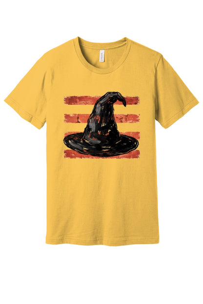 Black brushstroke witch hat on burnt-orange stripe Halloween graphic tee, DTF print, unisex cotton in Maizeyellow