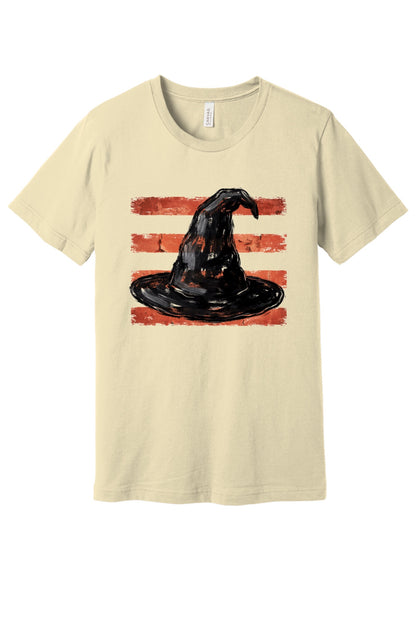 Black brushstroke witch hat on burnt-orange stripe Halloween graphic tee, DTF print, unisex cotton in Natural