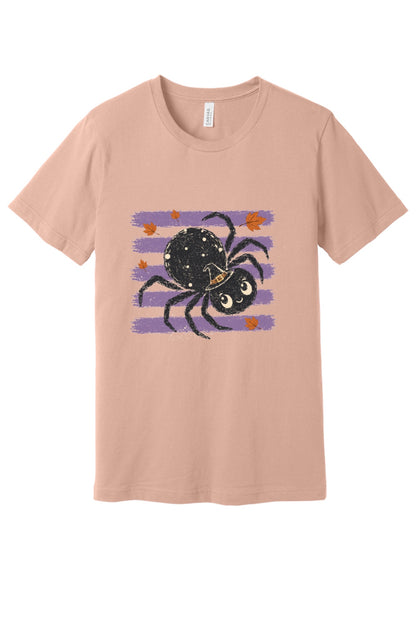 Cute black witch hat spider Halloween graphic printed on unisex short sleeve tee, purple stripe autumn leaves design in Peach